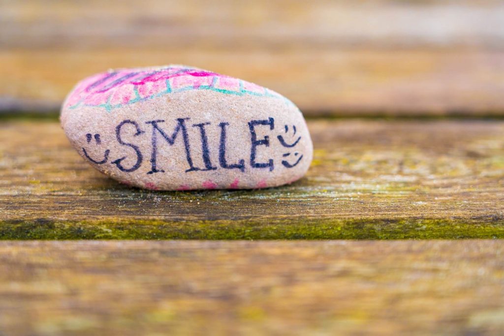 A rock with the word smile