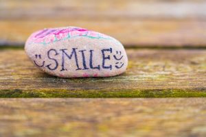 A rock reminding you to smile can help form a happiness habit.